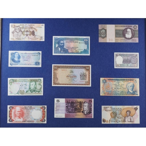 306 - A quantity of bank notes, coins and stamps from around the world, framed, and another similar smalle... 