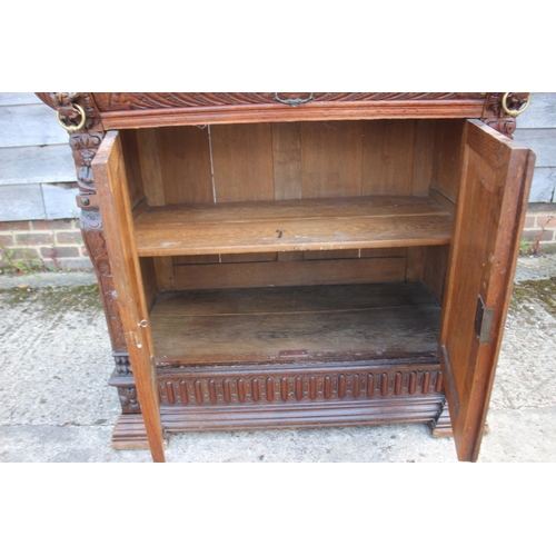 459 - An oak side cupboard of 17th century design, fitted one drawer over two panelled doors with lion mas... 