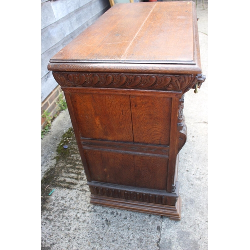 459 - An oak side cupboard of 17th century design, fitted one drawer over two panelled doors with lion mas... 