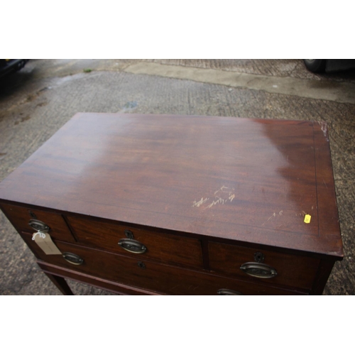 466 - A 19th century mahogany chest of three small and one long drawer with oval ring handles, on square t... 