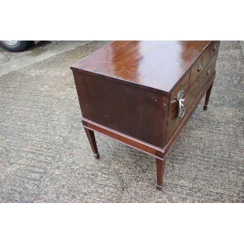 466 - A 19th century mahogany chest of three small and one long drawer with oval ring handles, on square t... 