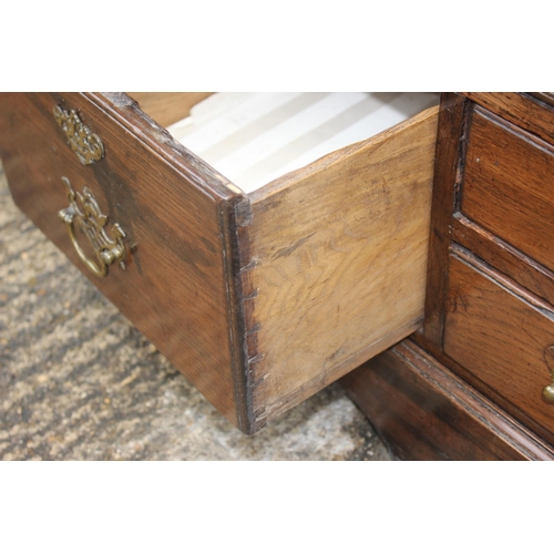 470 - An 18th century oak mule chest, now converted as a cupboard, enclosed two ogee panelled doors over t... 