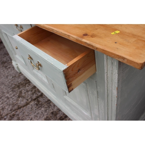 508 - A green painted dresser base with plate glass top, fitted three drawers over three doors, on block b... 