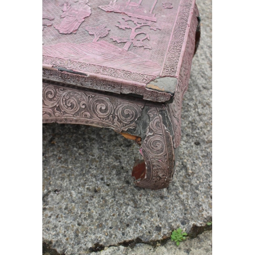 512 - A Chinese carved cinnabar lacquer low occasional table with figure and landscape decoration, on scro... 