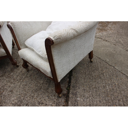 513 - A pair of 1930s carved hardwood showframe scroll arm deep seat easy chairs, on Braganza feet and bra... 