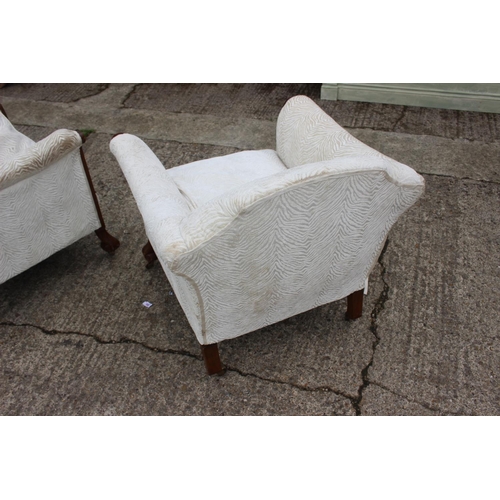 513 - A pair of 1930s carved hardwood showframe scroll arm deep seat easy chairs, on Braganza feet and bra... 