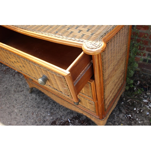 515 - A rattan bowfront chest of three long drawers, 36