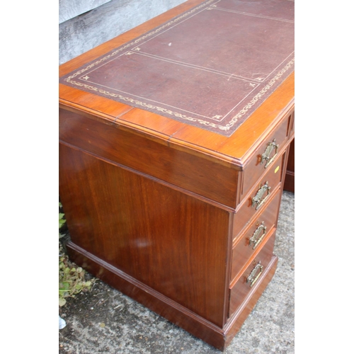 554 - An Edwardian walnut double pedestal desk with brown tooled leather top over three drawers and six fu... 