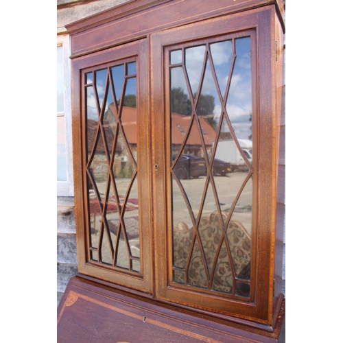 559 - An Edwardian mahogany and inlaid bureau bookcase, the upper section enclosed lattice glazed doors ov... 