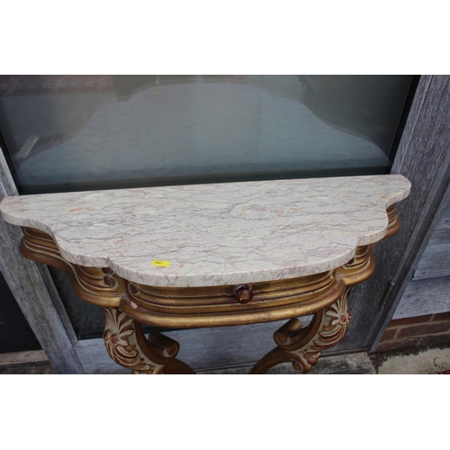 561 - A carved giltwood shaped marble top console table, fitted one drawer, on cabriole supports, 32