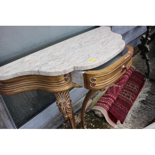 561 - A carved giltwood shaped marble top console table, fitted one drawer, on cabriole supports, 32