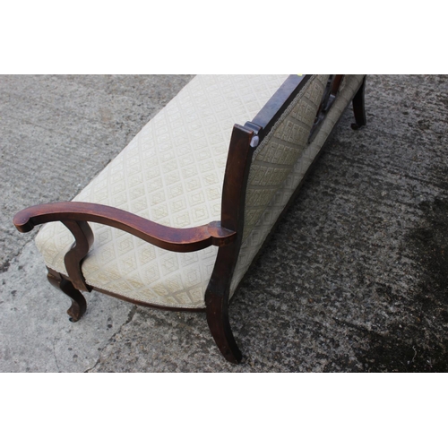 564 - An Edwardian carved walnut showframe two-seat settee with two-panel back, on cabriole castored suppo... 