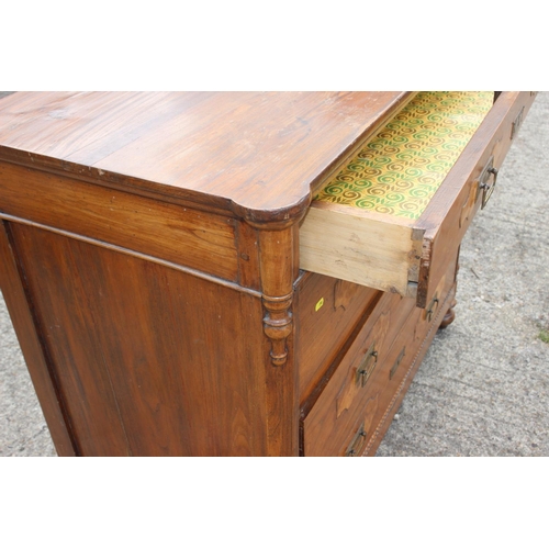 565 - An early 20th century Continental walnut inlaid chest of four drawers with brass square handles, on ... 