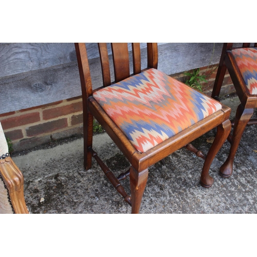 569 - A pair of Continental walnut splat back side chairs with drop-in seat, on cabriole supports