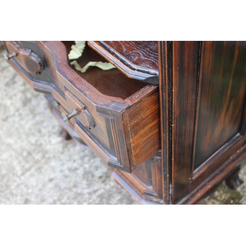 573 - A Continental carved walnut bedside chest of two drawers, on cabriole supports, 20