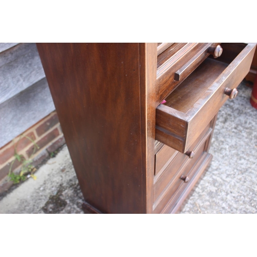 574 - A mahogany bookcase, fitted shelves over slide and three drawers with knob handles, 23