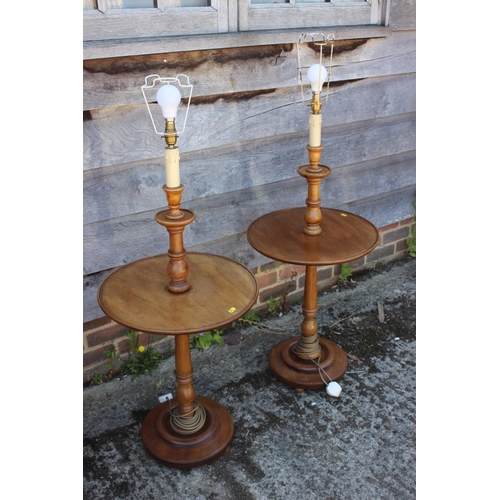 585 - A pair of early 20th century turned walnut lamp tables, on circular bases, 42