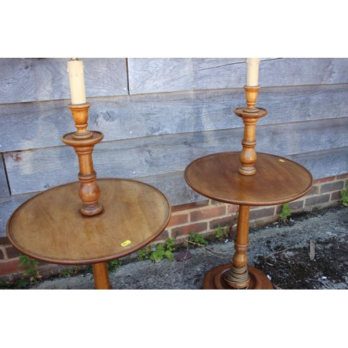 585 - A pair of early 20th century turned walnut lamp tables, on circular bases, 42