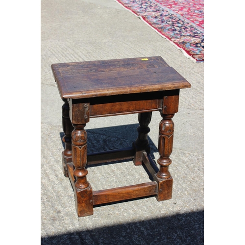 587 - An oak joint stool of 16th century design with carved turned supports united by stretcher rails, 17