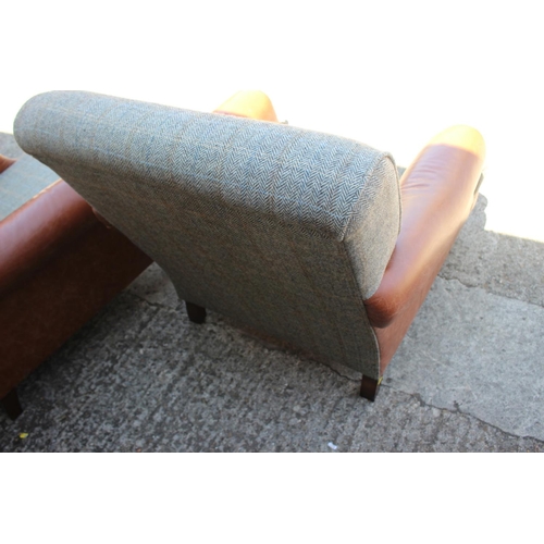 588 - A pair of leather and Harris tweed upholstered deep seat armchairs, on turned and castored supports