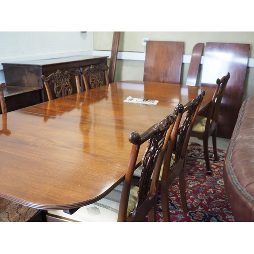 597 - An early 20th century mahogany triple pedestal dining table with two extra leaves, on turned columns... 