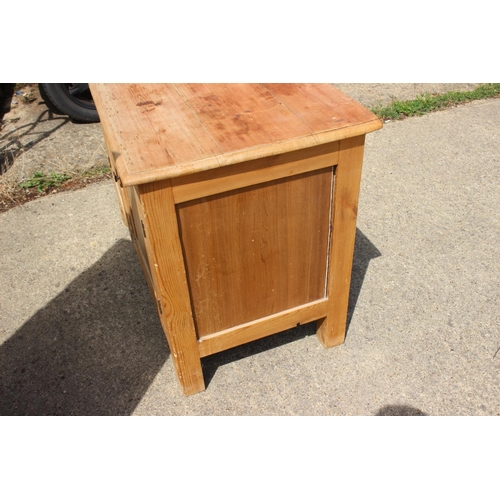 613 - A stripped pine side cupboard, fitted two doors, on square supports, 40