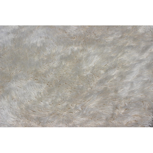 646 - A Flokati cream wool rug, 106