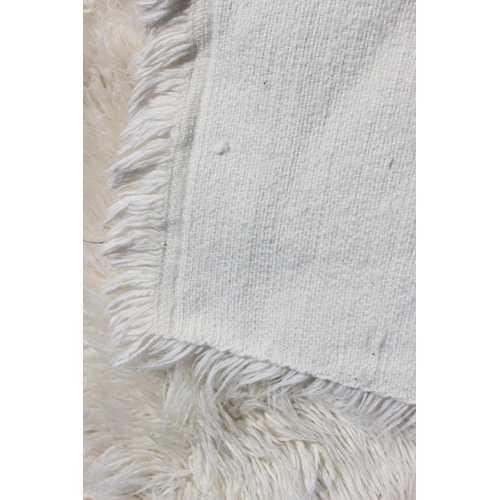 646 - A Flokati cream wool rug, 106