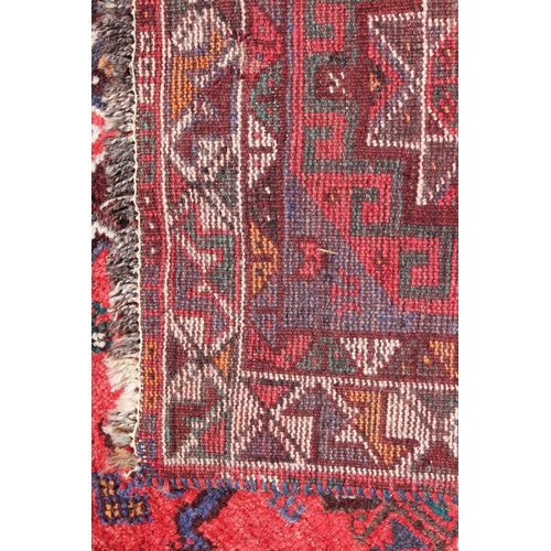 652 - A Qashqai design rug with three medallions on a bird and floral figured salmon ground and triple bor... 