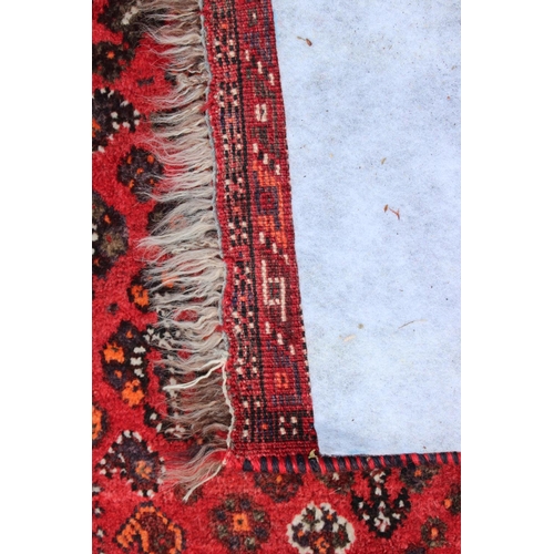 661 - A Qashqai design rug on a red ground and multi-bordered in shades of orange, green, red, black, brow... 