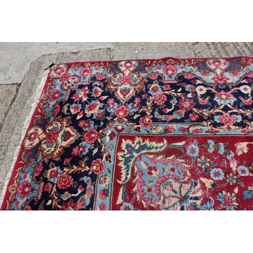 671 - A Persian city rug with floral design on a claret ground with deep borders, 118