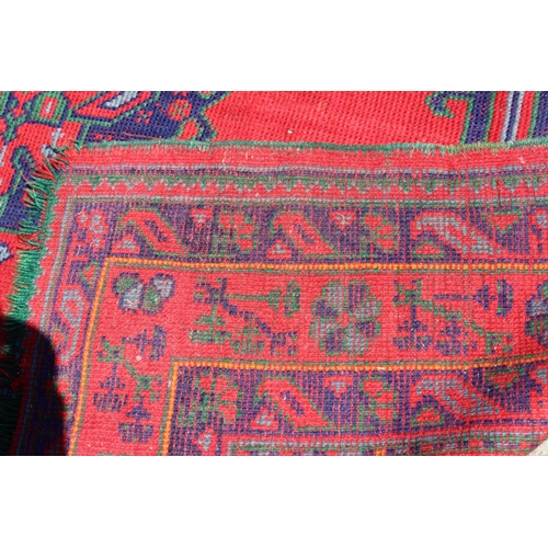 672 - A Turkey carpet of traditional design on a red ground 77