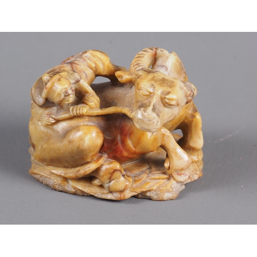 68 - A 19th century Chinese soapstone carving of a man on a water buffalo, 1 1/2” high (one horn missing)