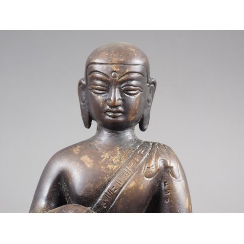 77 - A patinated bronze figure of Buddha, 5