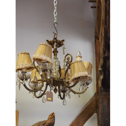 217 - A brass six-light chandelier with cut glass drops