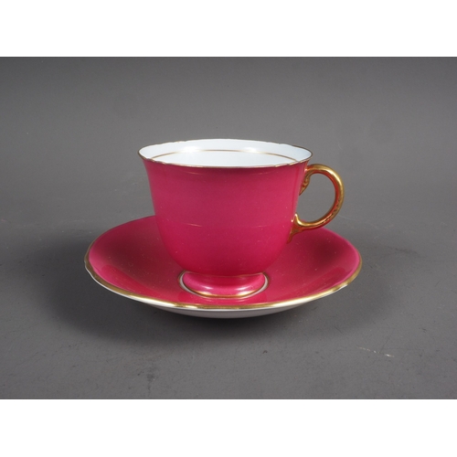 12 - A Mintons set of six teacups and saucers on a pink ground with gilt edge, in fitted box (one tea cup... 