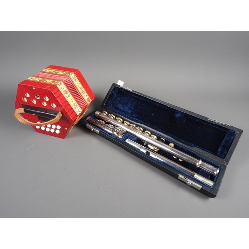 189 - A Sebastian Buckley silver plated flute, in fitted case, and a German Concertina