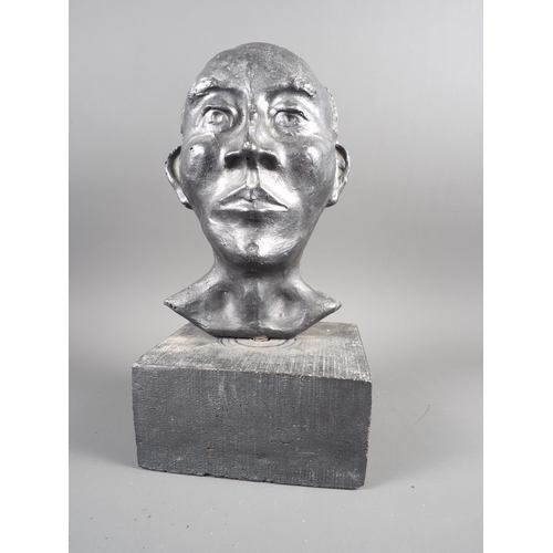 195 - A plaster bust of a bald man, on a square concrete base, 14” overall