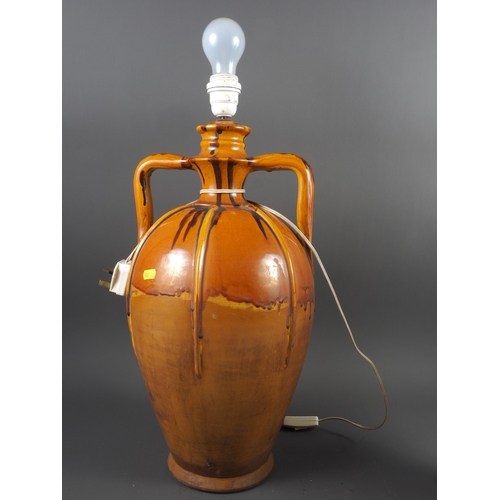 226 - An Italian two-handled orange glazed urn, now converted to a table lamp, 22