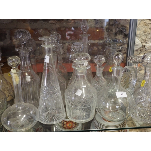 42 - Approximately sixteen cut glass and other decanters, various