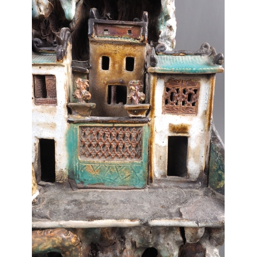 53 - A Chinese stoneware statue with buildings and figures, 19 1/4” high