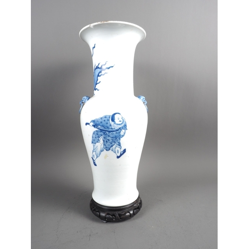 55 - A Chinese blue and white baluster and flared rim vase with mask handles and warrior decoration, six-... 