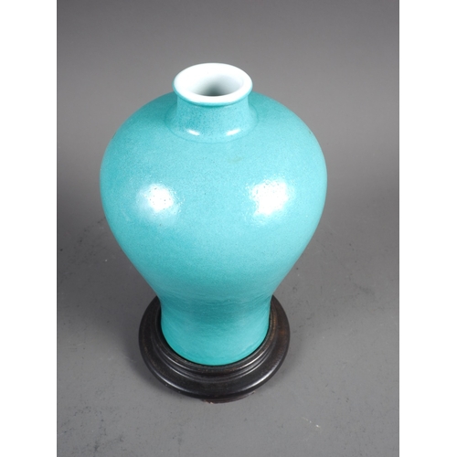 56 - A Chinese meiping turquoise glazed vase, 6 3/4” high, on turned hardwood stand