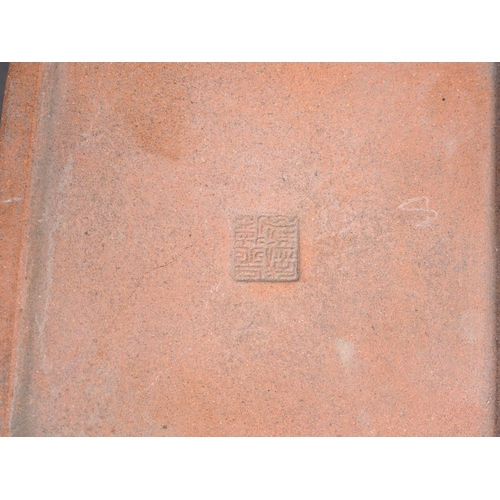 61 - A Chinese terracotta square-shaped box and cover with character decoration and seal mark to base, 3 ... 