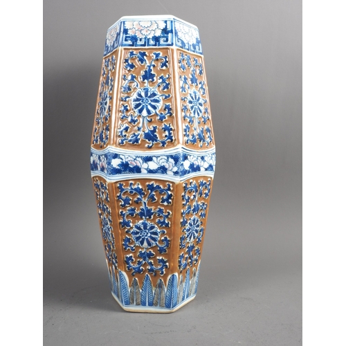 66 - A Chinese blue and white relief decorated hexagonal vase with cafe-au-lait ground, 13 1/2