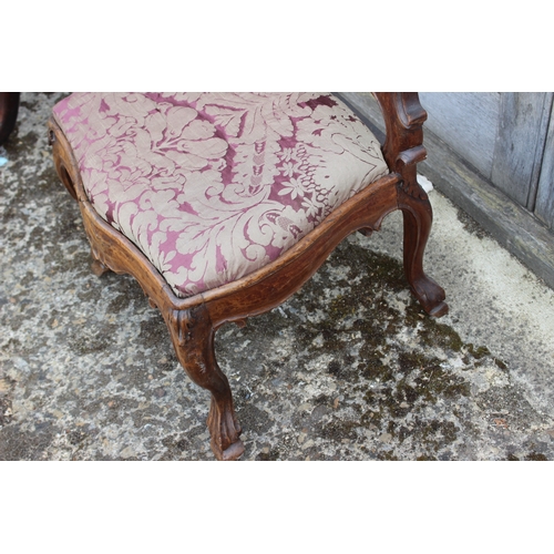 435 - A 19th century carved walnut nursing chair with shaped splat and drop-in seat, upholstered in floral... 