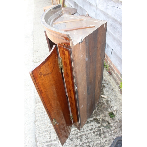 439 - A late Georgian provincial oak and inlaid bowfront corner cupboard, enclosed two doors with strap, 2... 