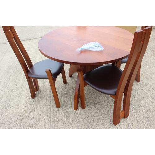 527 - A modern cherrywood circular dining table, on tripod splay support, 42