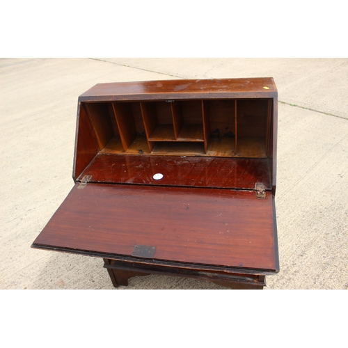 529 - An Edwardian walnut and inlaid fall front bureau with fitted interior over three long drawers, 30