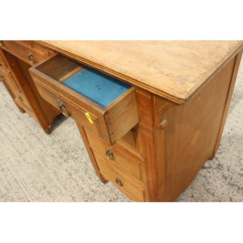 530 - An ash double pedestal desk, fitted nine drawers, on turned supports, 54